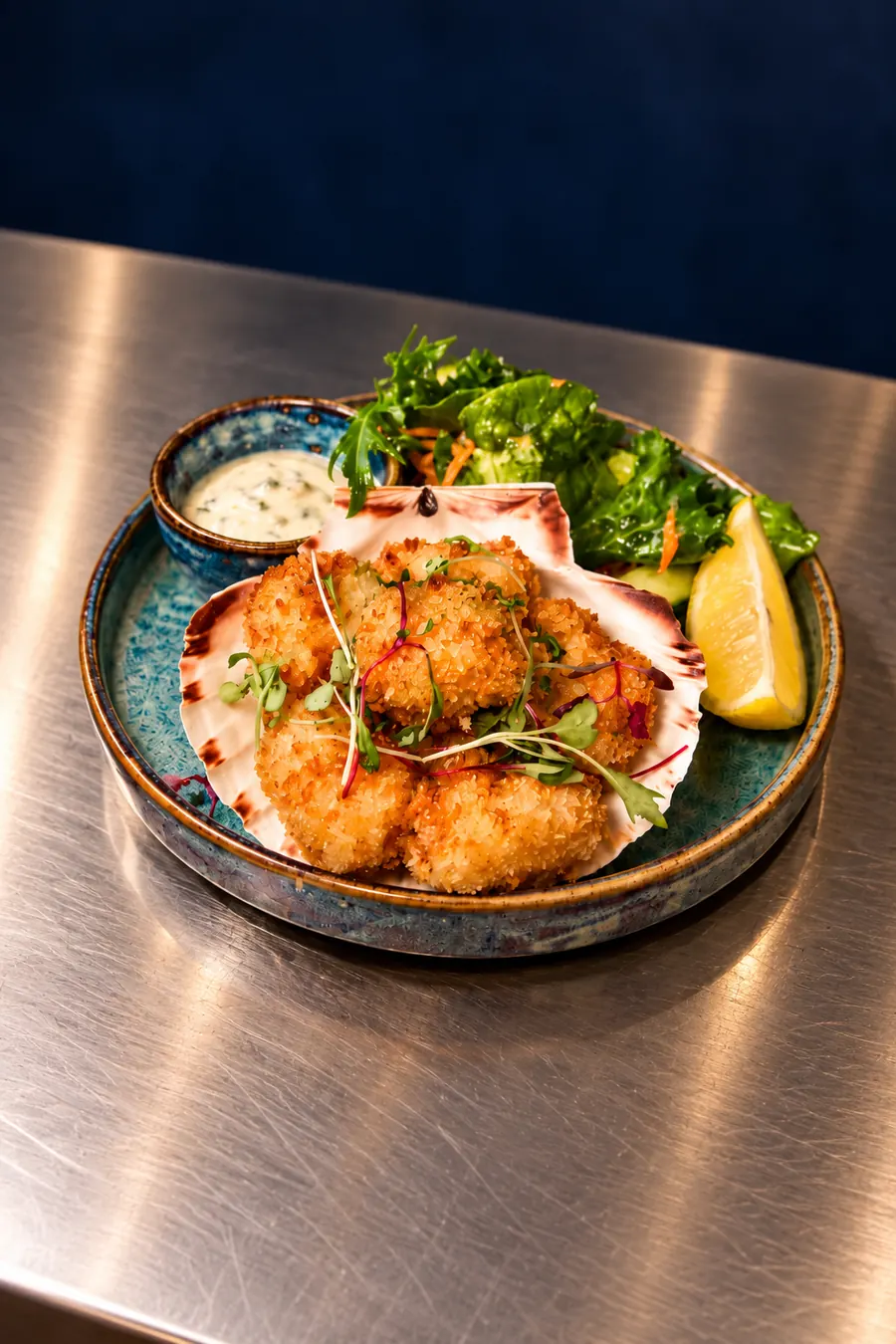 Breaded scallops served on the shell