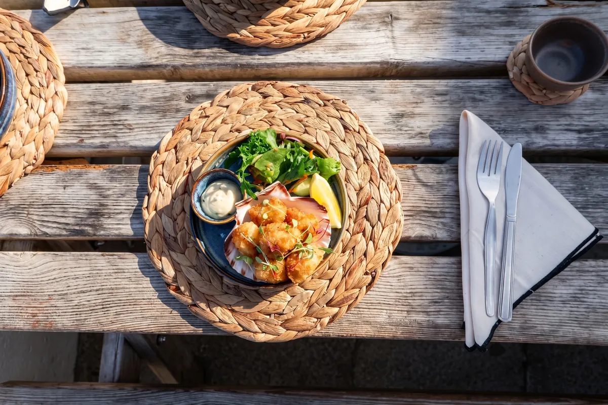 Scampi with tartare and lemon, laid on the terrace table